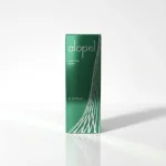 Зелена картонна упаковка піни Alopel. Засіб зменшує оксидативний стрес у волосяних фолікулах та зупиняє випадіння волосся.